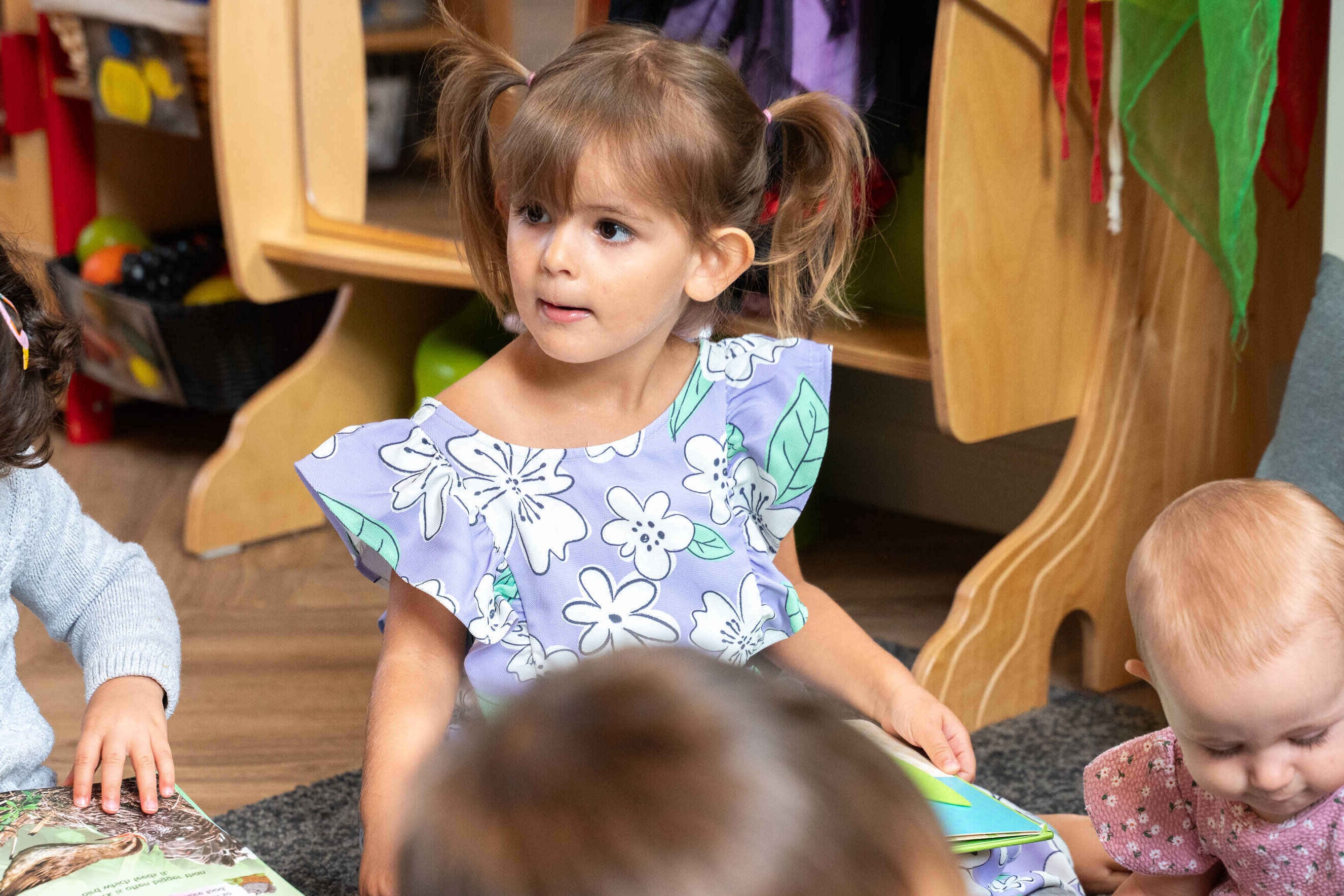 Girl reading at Basker Pre-School