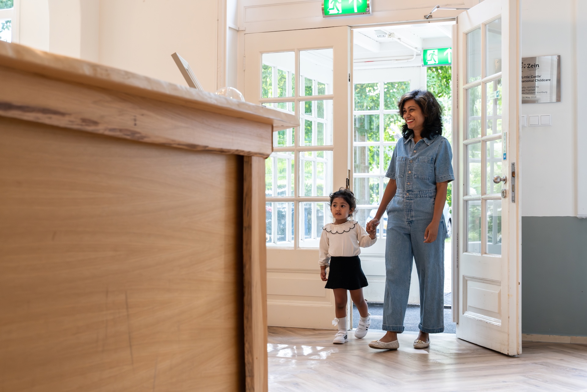 Mother and little girl arrive at international daycare