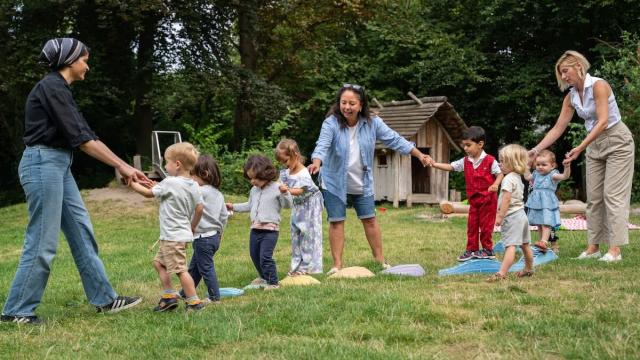 Teachers and children playing outside