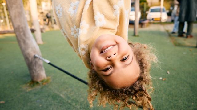 Girl hanging upside down at Basker International Childcare