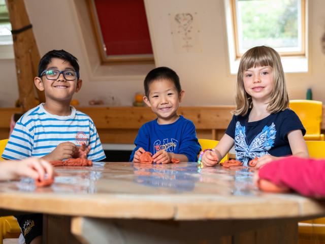 Basker International children playing with clay