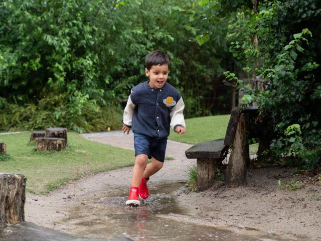 Boy running through puddles