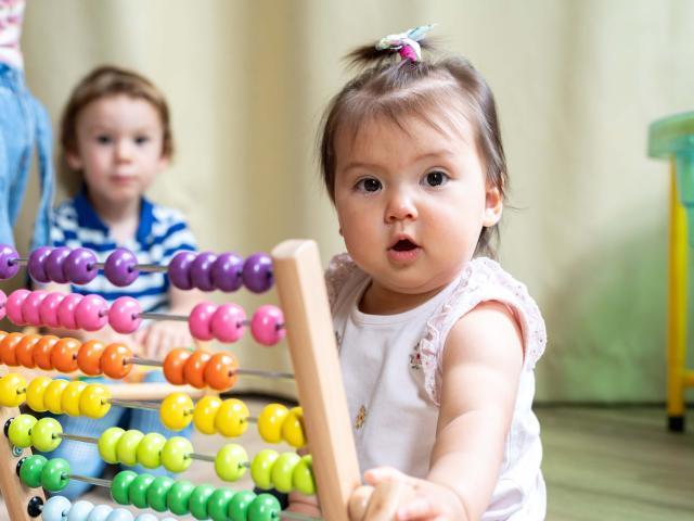 Girl playing with abacus at Day Care