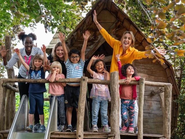 teachers and children in a tree house at Basker International Childcare