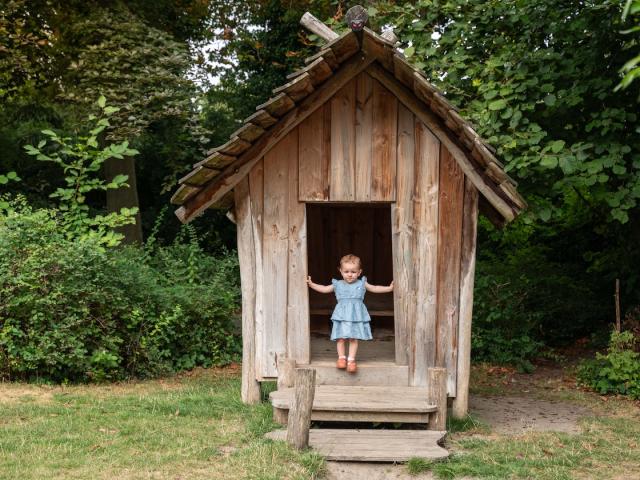 Girl standing in a wooden house at Basker International Childcare