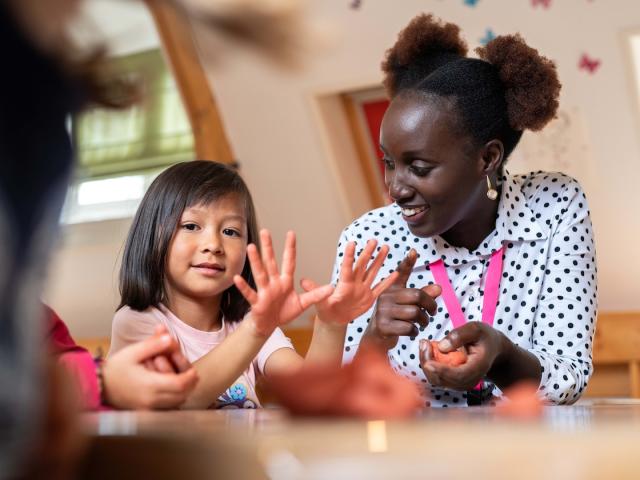 Girl and teacher talking with each other