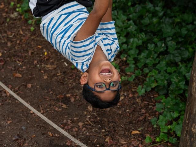 Boy hanging upside down