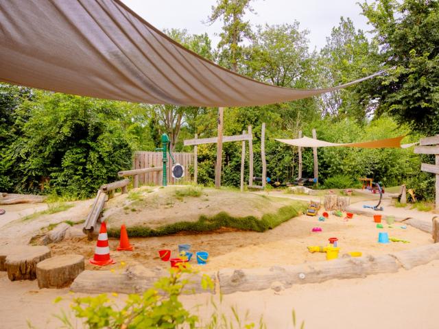 Garden with sandbox and playground equipment Basker International The Maples The Hague 