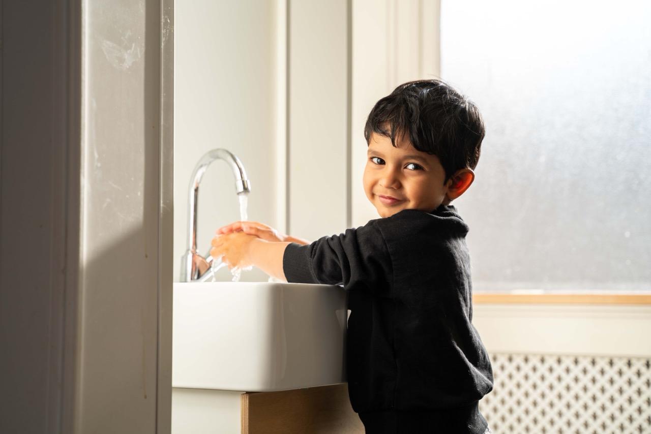 Basker International Childcare Pre-School boy is washing hands
