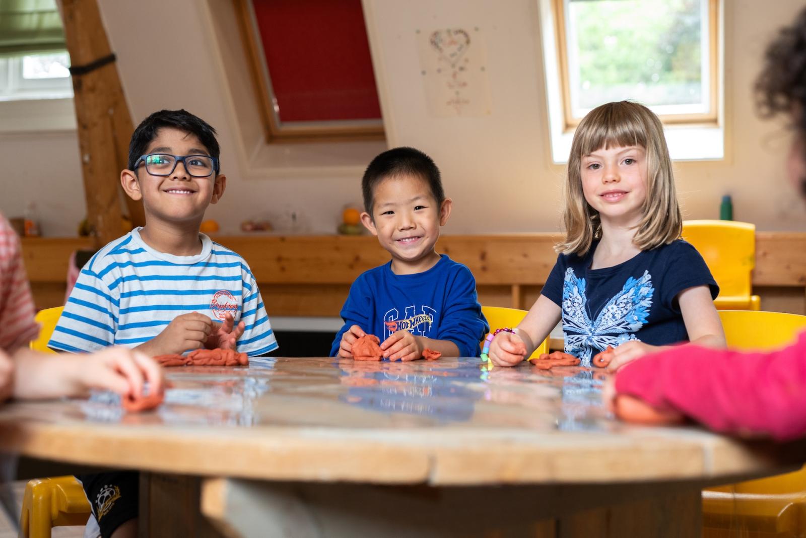 Basker International children playing with clay