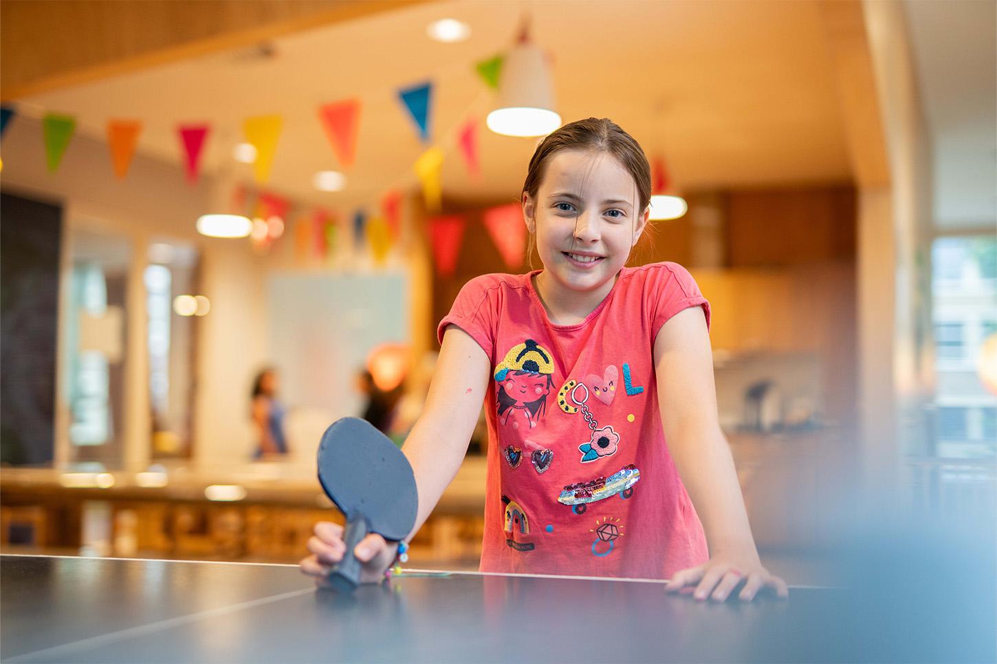 Girl playing table tennis at Basker International Childcare