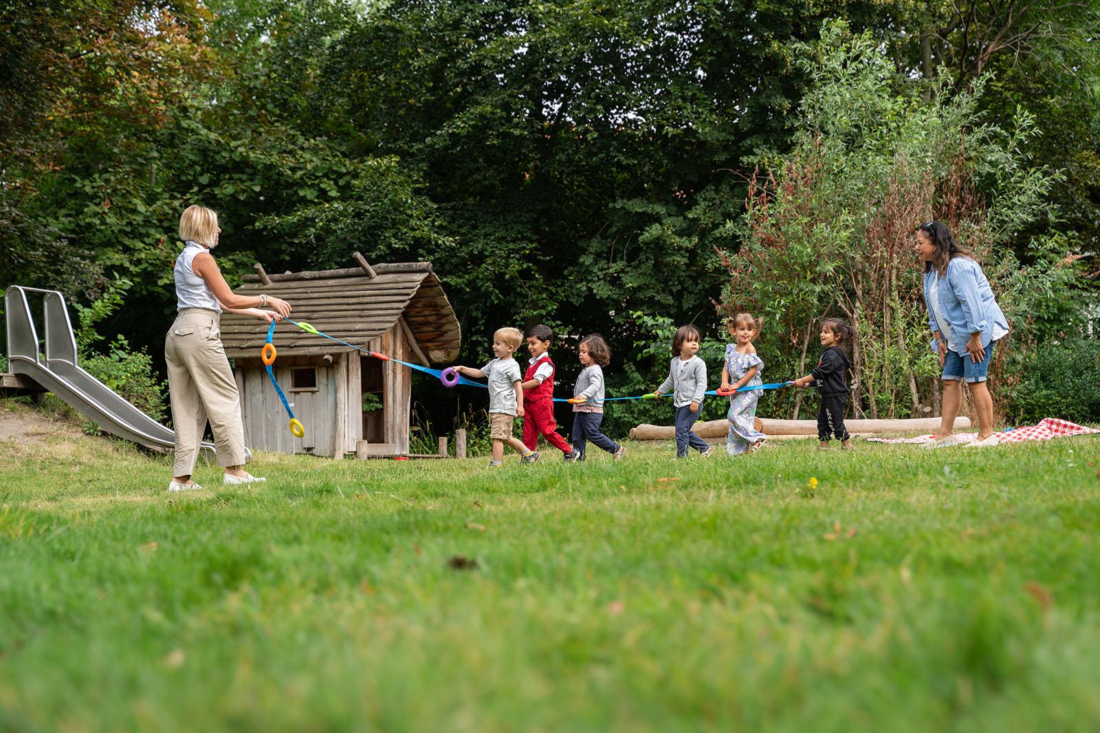 Teachers and children doing an activity outside