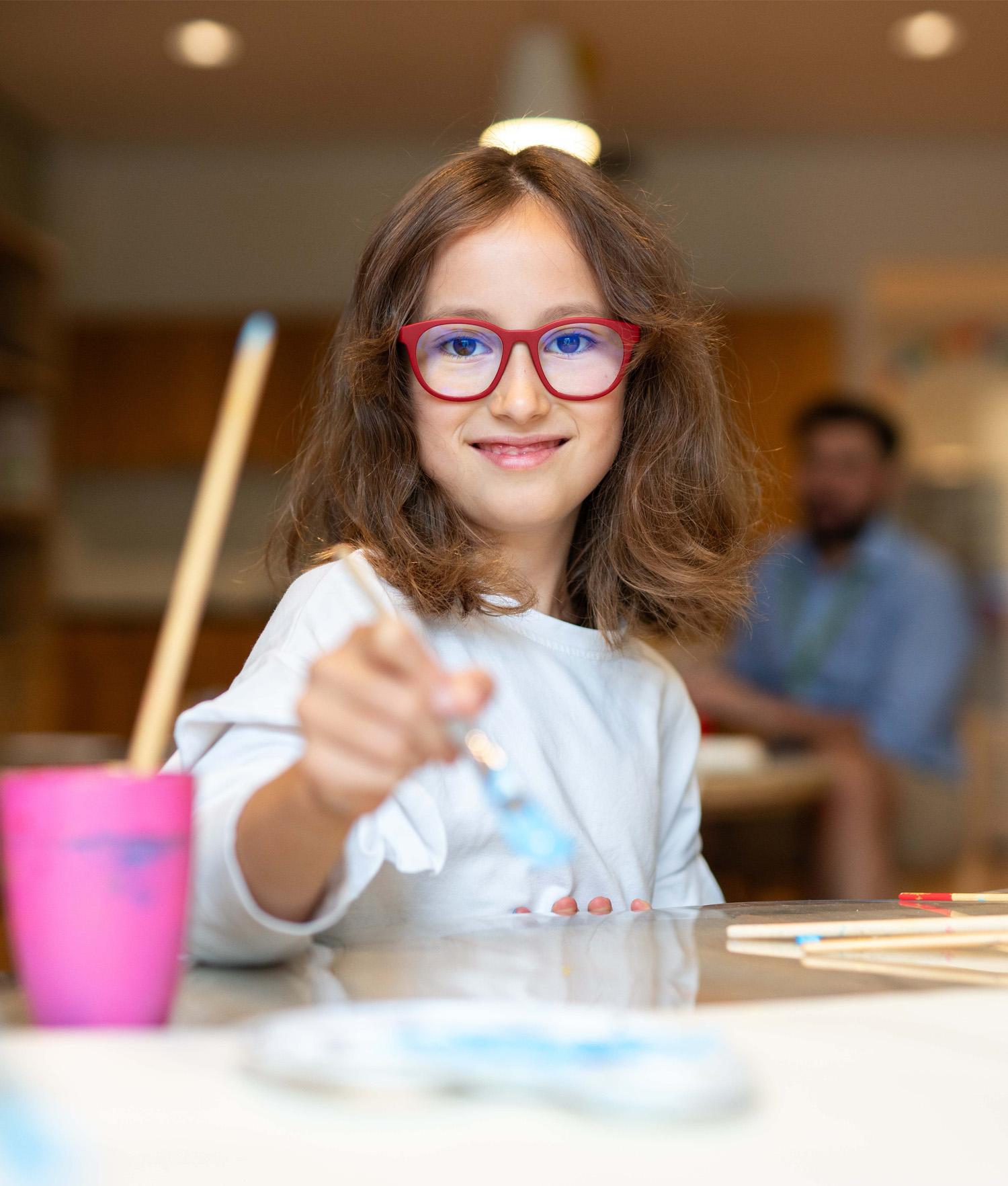 Basker International Childcare Partner Schools girl with paint brush