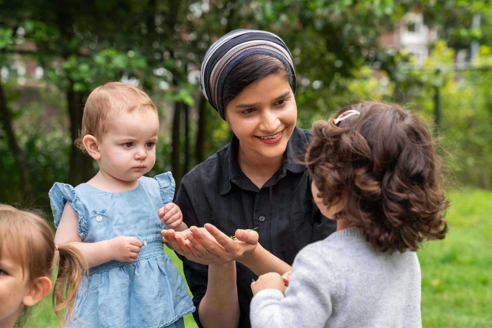 Childcare teacher interacts with children 