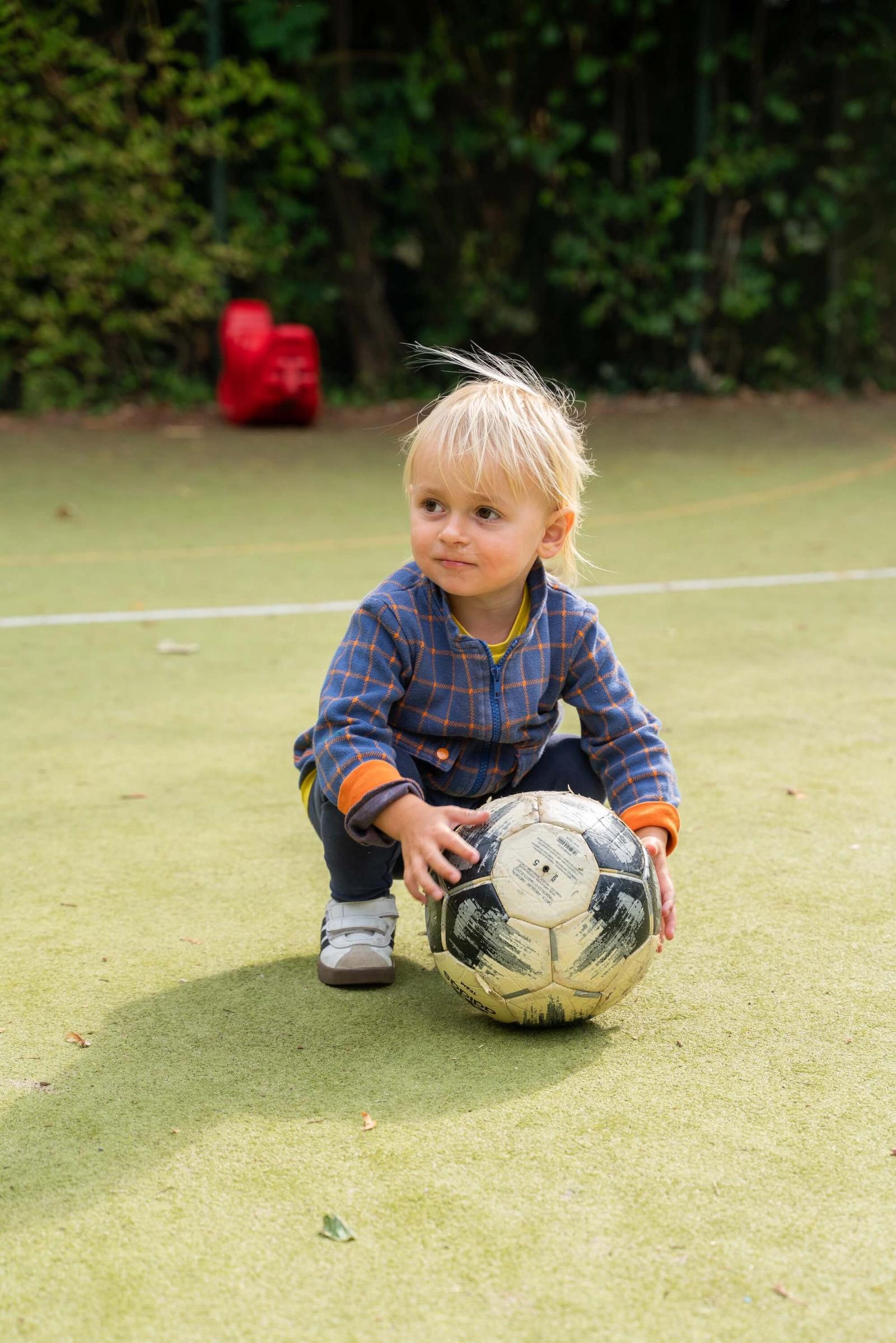 Boy playing with a ball at Basker International Childcare