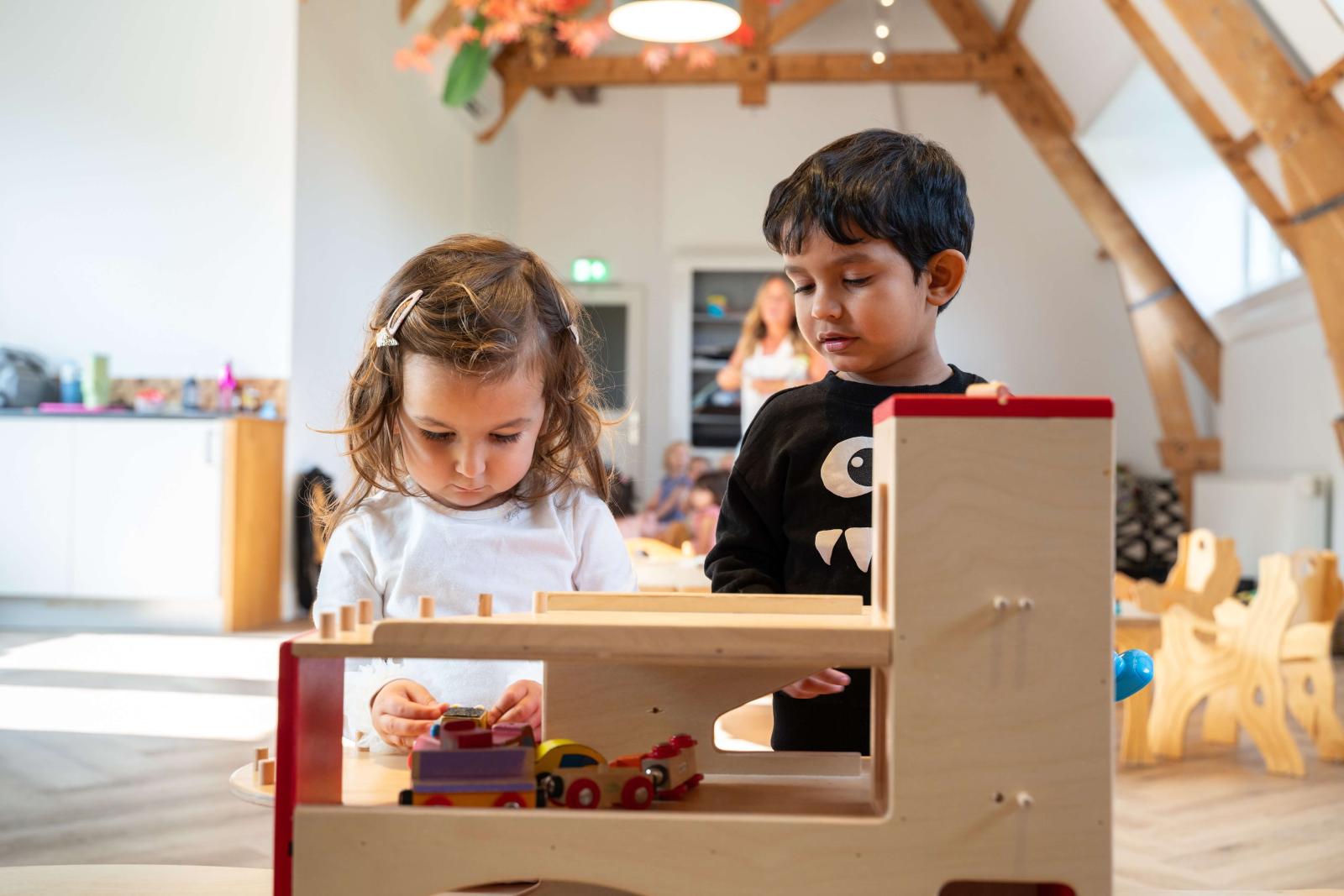 Girl and boy playing with wooden toys