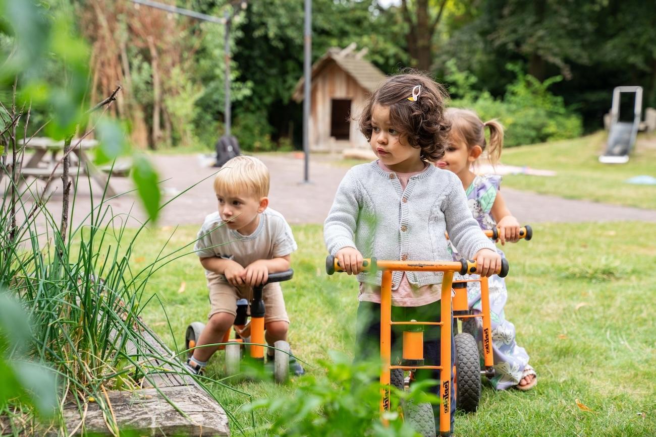Children playing outsite on a bike