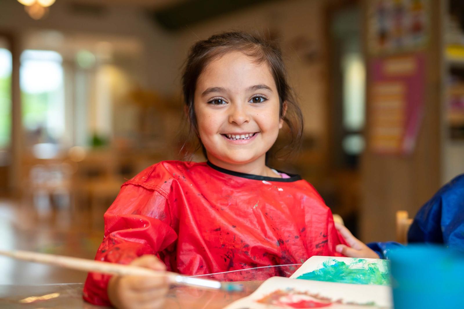 Girl painting at after school care