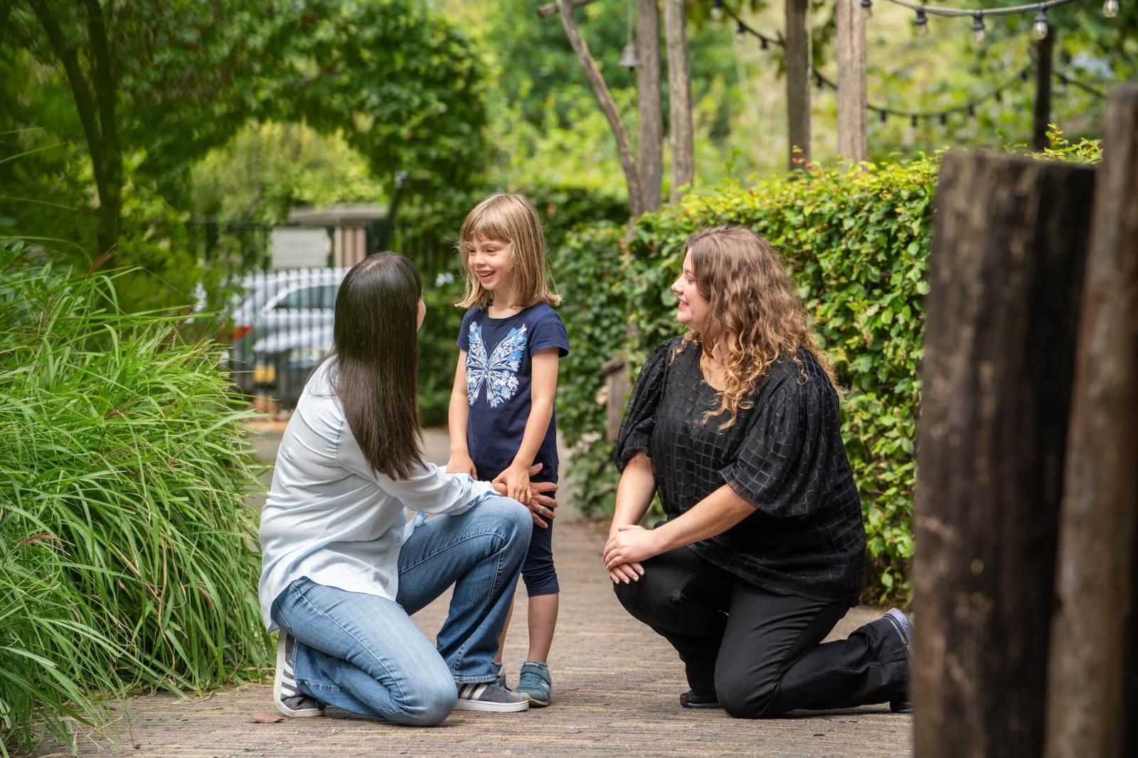 Mother daughter and teacher saying goodbye