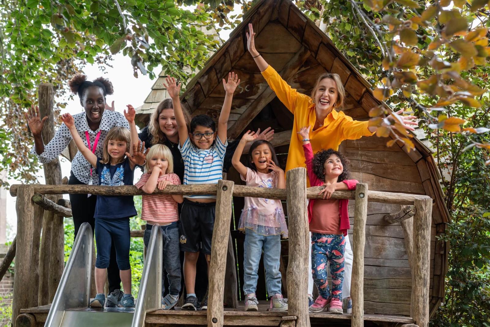 teachers and children in a tree house at Basker International Childcare