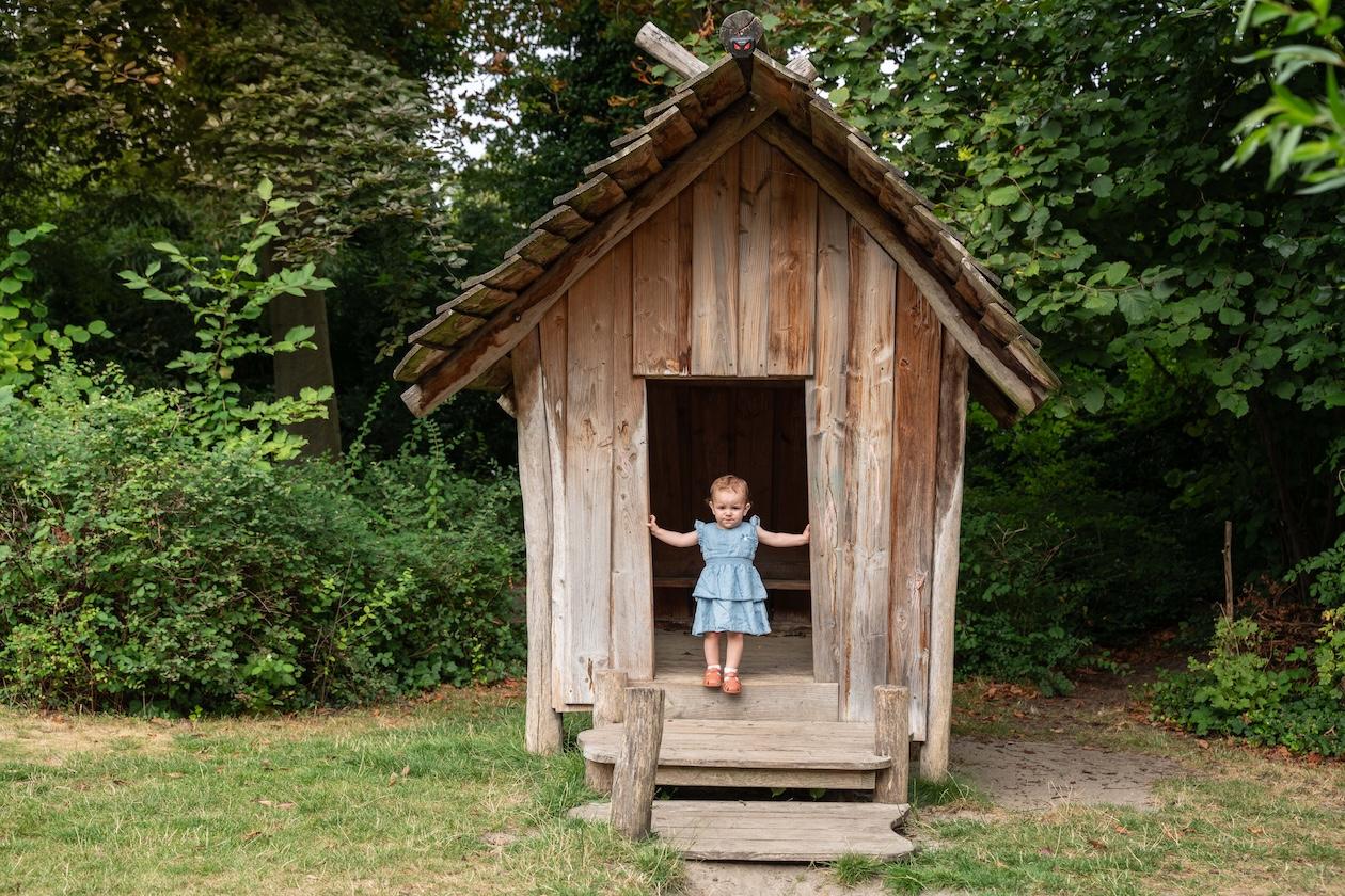 Girl standing in a wooden house at Basker International Childcare