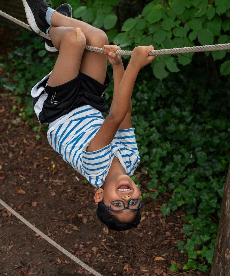 Boy hanging upside down
